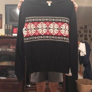 Black, white, red sweater. Size large. Never worn